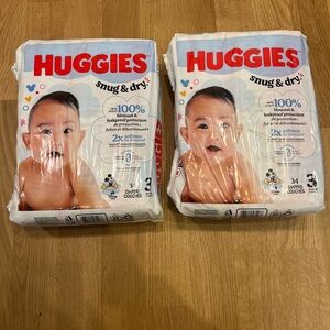 2 Packs of 34 Huggies Snug & Dry Diapers - Disney Print